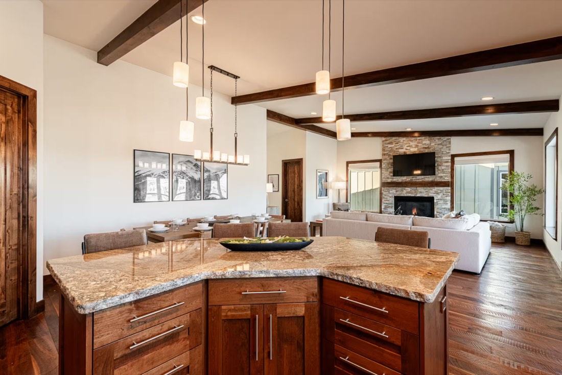 Open-concept great room and gourmet chef's kitchen with granite island and fireplace overlooking Jordanelle