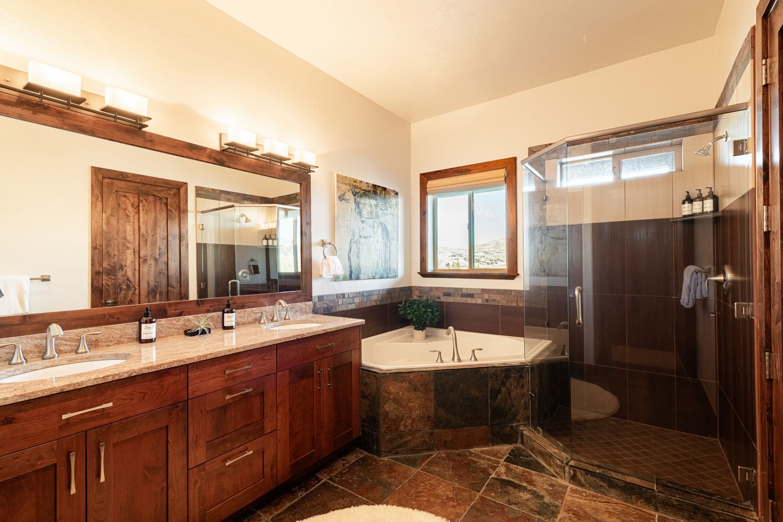 Guest suite ensuite bathroom with corner soaking tub and walk-in shower