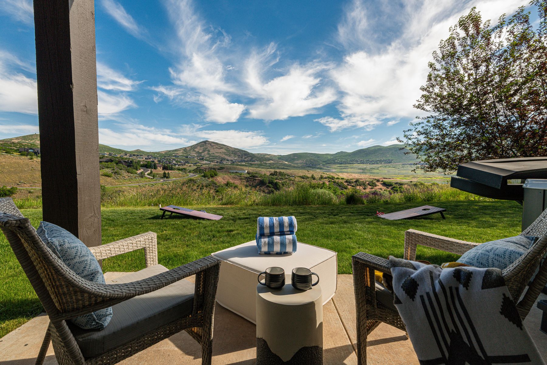 Private backyard lawn with cornhole and mountain vistas at Mayflower Vista