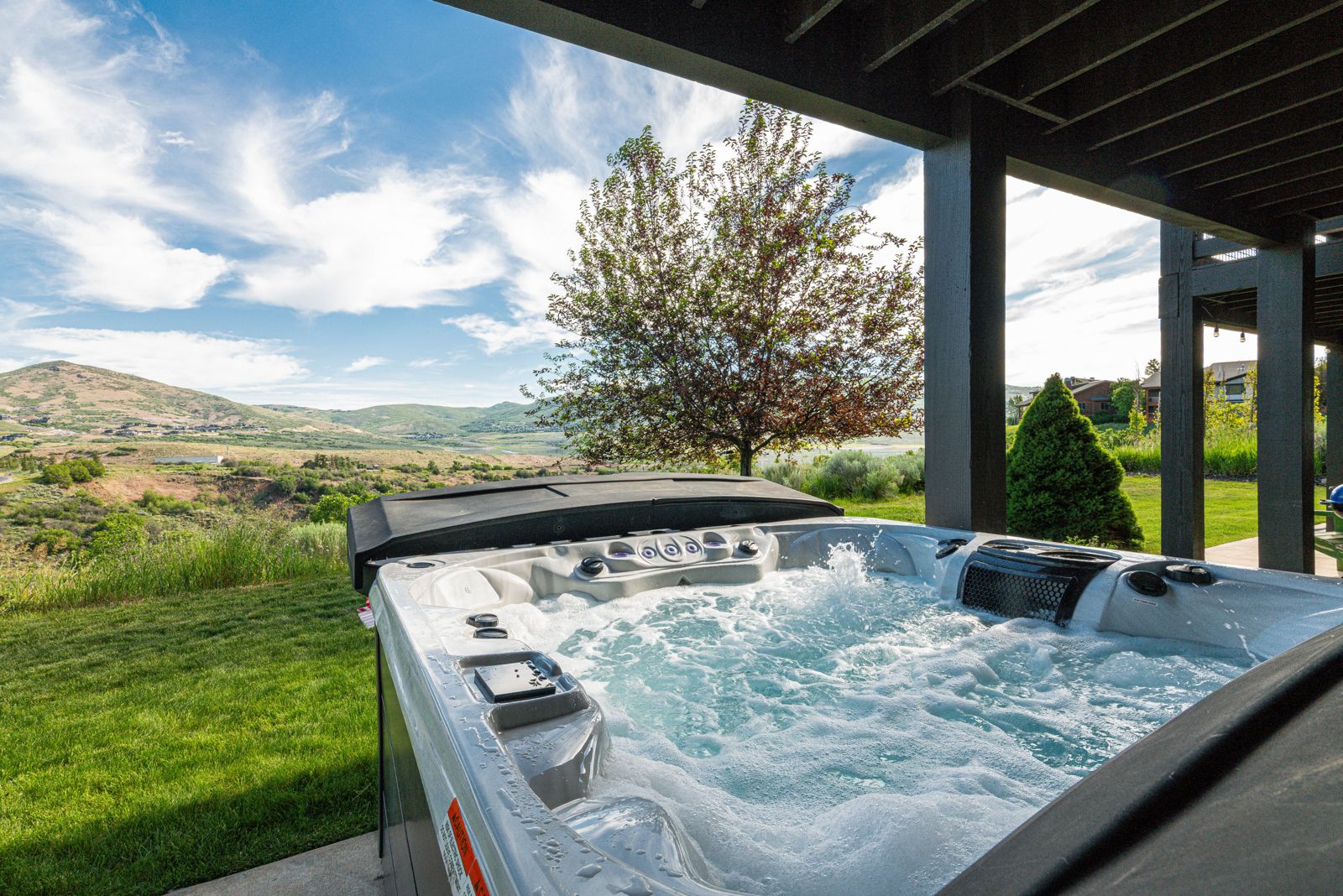 Private outdoor hot tub with alpine and mountain views at Mayflower Vista