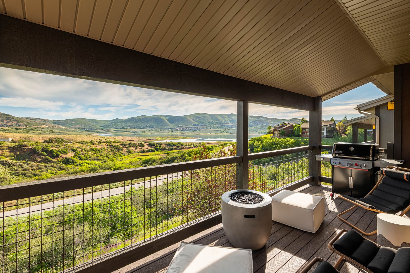 Spacious outdoor view deck with seating overlooking Jordanelle Reservoir and Wasatch mountains