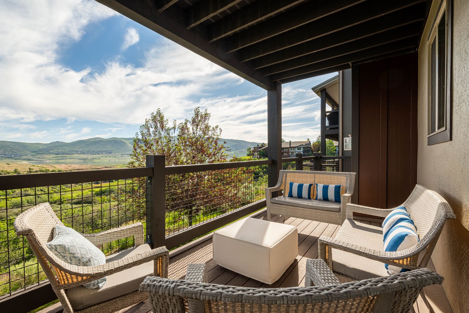 Private patio and hot tub deck with panoramic mountain and lake views