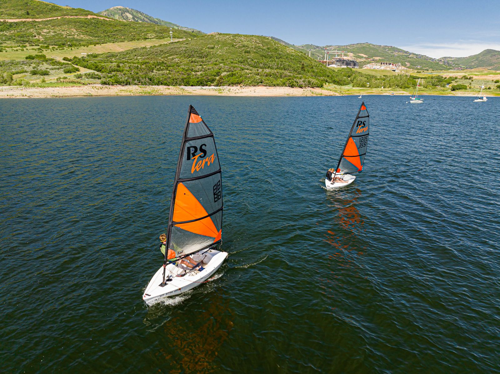 Sailboats cruising on Jordanelle Reservoir with Wasatch Mountain views